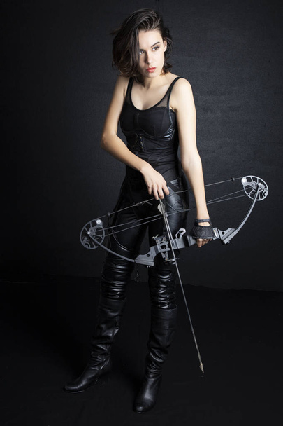 Woman in urban-fantasy style costume posing with a variety of weapons - Fotoğraf, Görsel