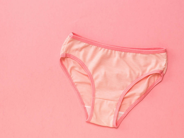 Pink panties with red border on pink background. The concept of meeting lovers. Underwear. The view from the top. - Photo, Image