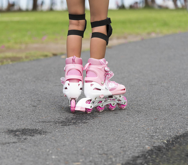 Little girl with rollerblades in park - Photo, image
