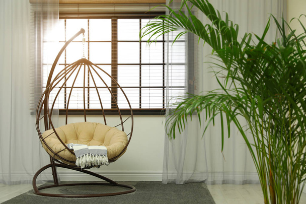 Comfortable swing chair with pillow in room interior - Φωτογραφία, εικόνα