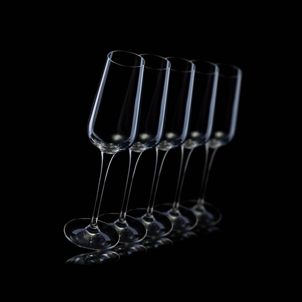 Set of empty luxury champagne glasses in a row isolated on a black background - Photo, image