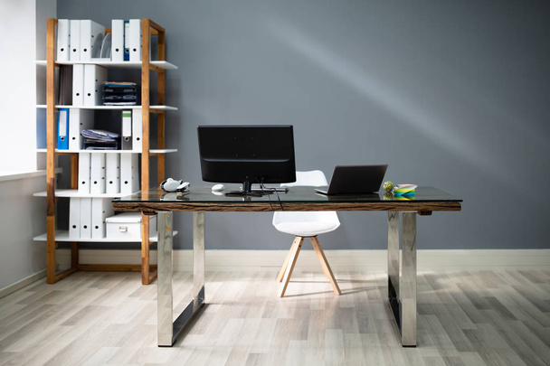 Computer And Laptop On Desk In Modern Interior Office - 写真・画像