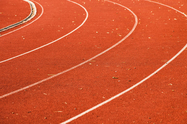 closeup of athletic red running tracks whit white lines and some - Photo, Image