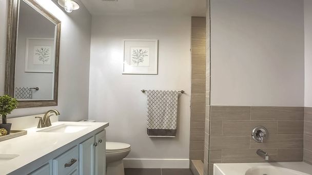 Panorama Interno del bagno con vasca di fronte a te zona vanità e specchio
 - Foto, immagini