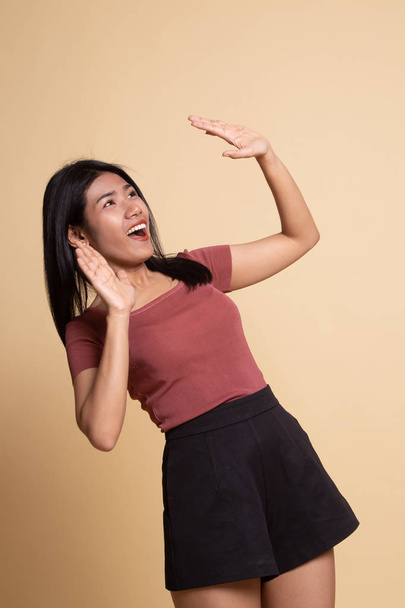 Excited young Asian woman look up. - Foto, Imagen