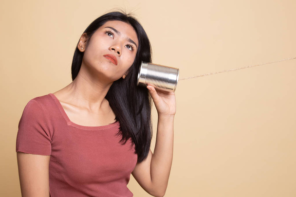 Young Asian woman with tin can phone. - Фото, зображення