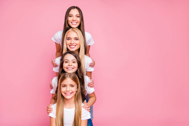 Nice attractive lovely glad cheerful cheery tender girls enjoying building vertical top pyramid harmony idyllic relations supporting each other guarantee security isolated on pink background - Fotoğraf, Görsel