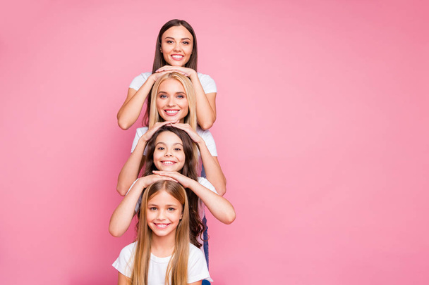 Nice attractive lovely diverse multinational glad cheerful cheery funny funky girls relatives having fun building vertical generation duties relations isolated over pink pastel background - Fotoğraf, Görsel