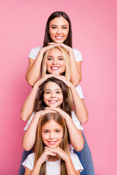 Vertical view of nice attractive lovely diverse multinational adorable glad cheerful cheery funny girls relatives having fun holiday weekend free time isolated over pink pastel background - Foto, Imagen