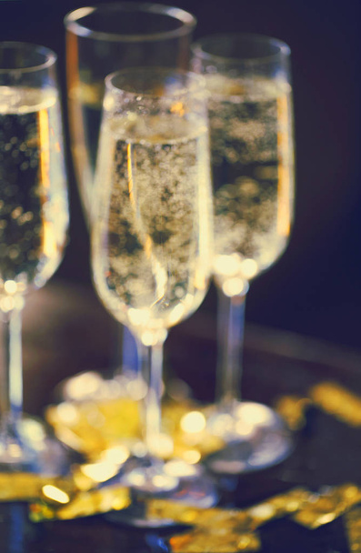 Champagne Flutes In Golden Sparkle Background with golden confet - Φωτογραφία, εικόνα