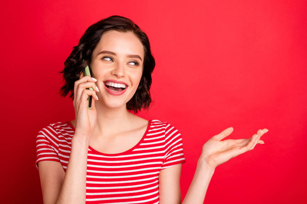 Close-up portrait of her she nice attractive lovely cheerful cheery friendly wavy-haired girl talking wireless connection isolated over bright vivid shine red background - Foto, Imagen