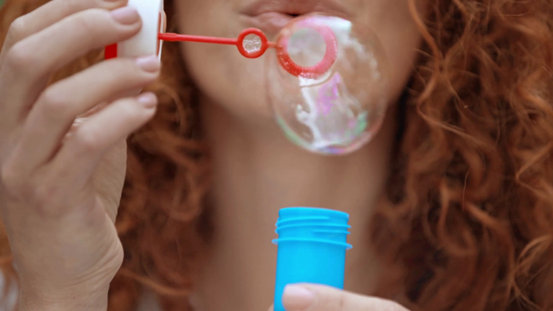 cropped view of happy girl blowing soap bubbles  - Footage, Video