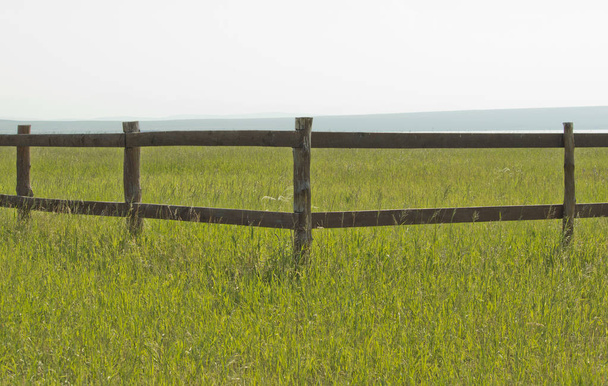 wooden fence in the field in daylight - Photo, Image