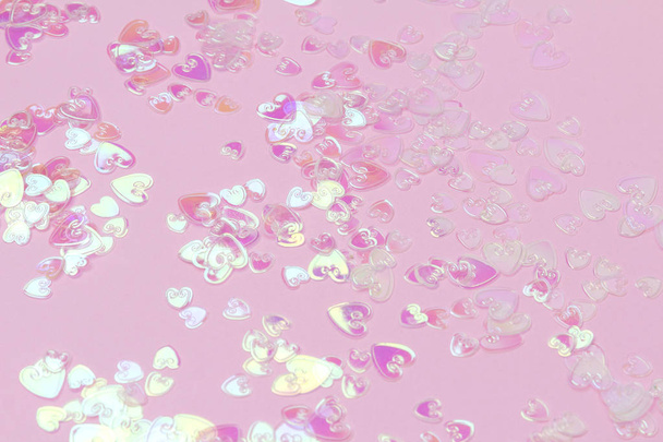 Heart holographic confetti sparkles on pink background - Photo, Image