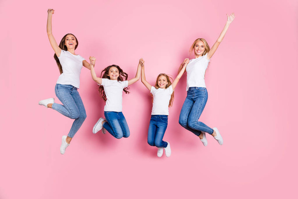 Full length body size view of four nice attractive lovely slim fit cheerful glad long hair girls having fun spending holiday weekend holding hands motherhood isolated on pink background - Photo, image