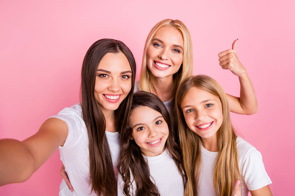 Self-portrait of four nice attractive lovely charming cute cheerful cheery long hair girls showing thumbup ad advert decision choose choice motherhood isolated over pink pastel background - Photo, image