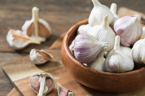 Garlic on a grey wooden table. Rustic style - Photo, Image