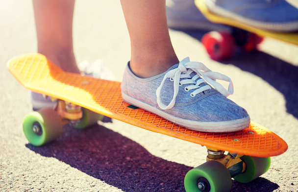 close up of female feet riding short skateboard - Fotó, kép