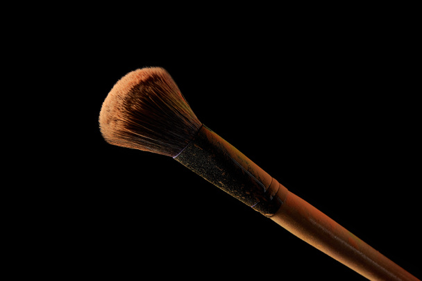 cosmetic brush isolated on black background with copy space - Фото, зображення
