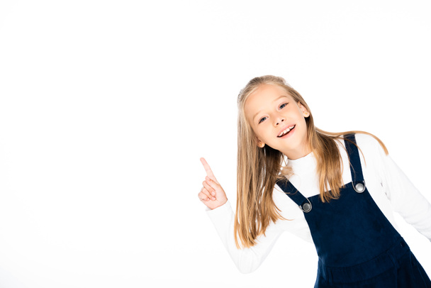 cute, smiling schoolgirl showing idea sign while looking at camera isolated on white - Photo, Image