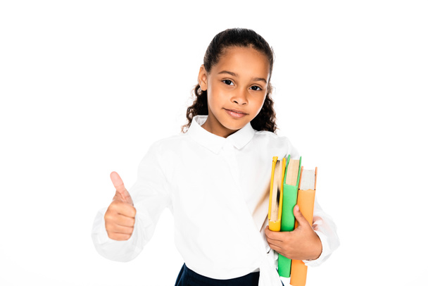 adorable african american schoolgirl showing thumb up while looking at camera isolated on white - Zdjęcie, obraz