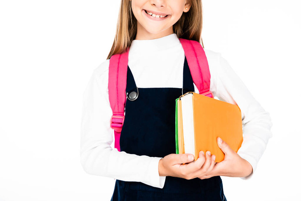 rajattu näkymä hymyilevä koulutyttö tilalla kirjoja eristetty valkoinen
 - Valokuva, kuva