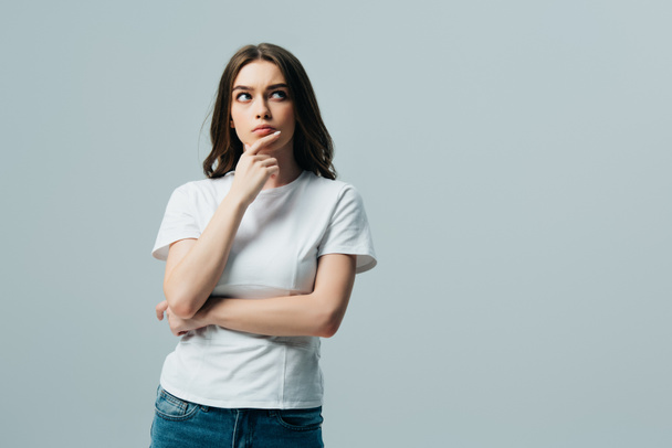 serious thoughtful beautiful girl in white t-shirt looking away isolated on grey - Fotoğraf, Görsel