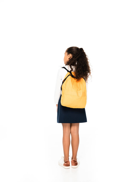 back view of african american schoolgirl with yellow backpack on white background - Foto, immagini