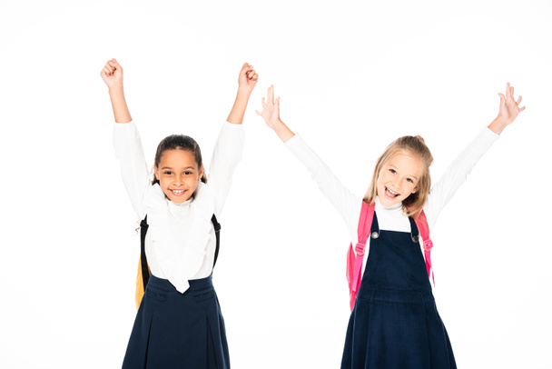 two happy multicultural schoolgirls showing yes gestures isolated on white - Foto, Imagem