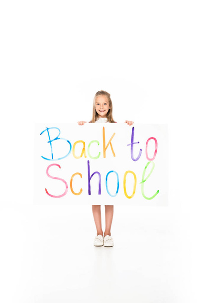 cute schoolgirl holding placard with back to shool inscription on white background - Фото, изображение