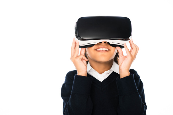 smiling african american schoolgirl using virtual reality headset isolated on white - Fotoğraf, Görsel