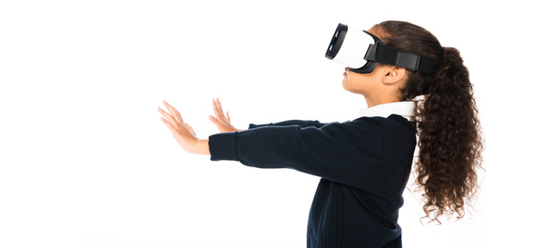 panoramic shot of african american schoolgirl using virtual reality headset isolated on white - Fotoğraf, Görsel