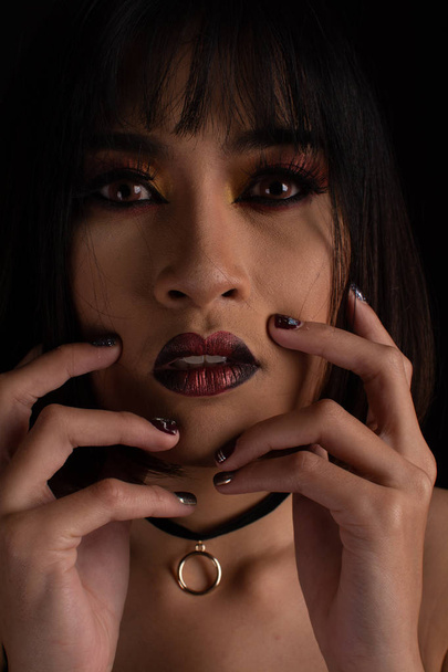 Southeast asian woman with dark tone makeup on black background, - 写真・画像