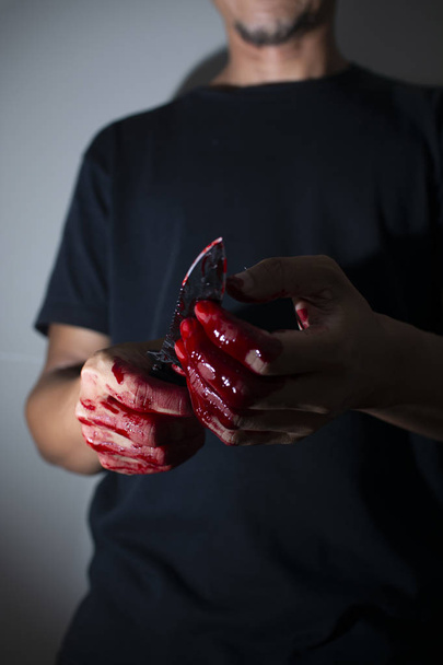 Psychotic murderer and a knife in his bloody hands - 写真・画像