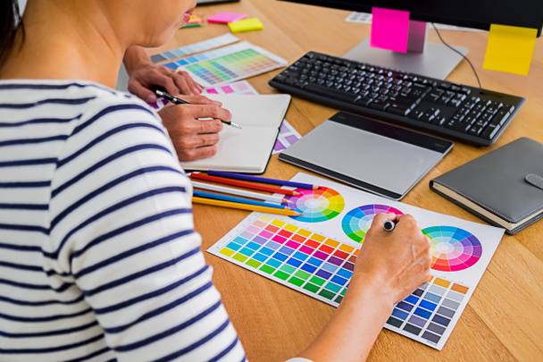 Γραφικός σχεδιασμός με δείγματα χρωμάτων και tablet σε ένα γραφείο. Γραφικό - Φωτογραφία, εικόνα
