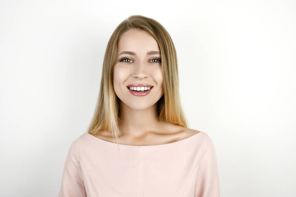 young beautiful blonde smiling woman on isolated white background - Фото, зображення