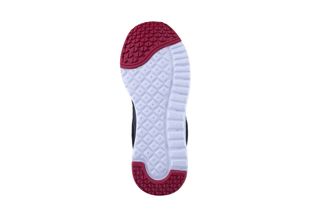 Rode en witte rubberen zool met sneakers op een witte achtergrond. - Foto, afbeelding