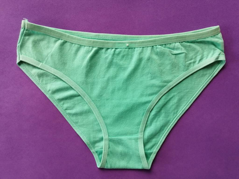 Minsk, Republic of Belarus August 08, 2019 Inverted new clean womens underpants of blue color on a lilac background shot in real close-up shot - 写真・画像