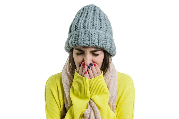 Woman caught a cold in warm hat and scarf with handkerchief, isolated on white background, flu season - Fotó, kép