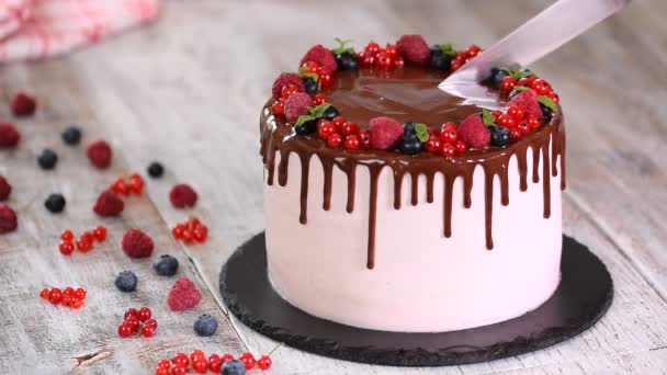 Beautiful homemade cake with summer berries, chocolate frosting on white tabl. - Footage, Video