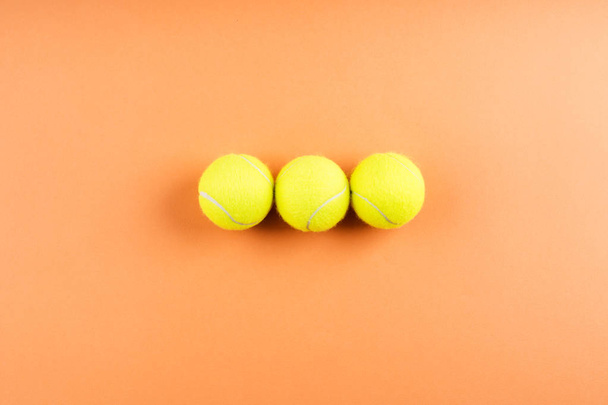 Three tennis balls on orange. Concept - Foto, Imagen
