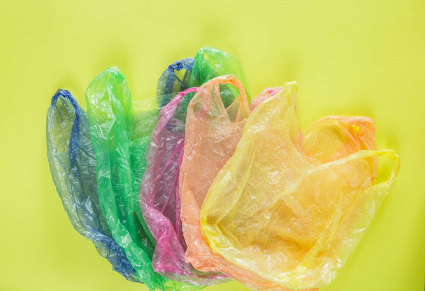 colorful plastic bags on a green background - Photo, image