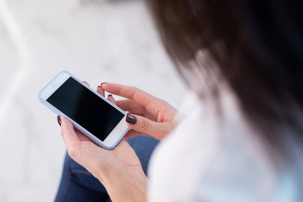 Cropped photo of woman holding her digital device in hands - Photo, Image