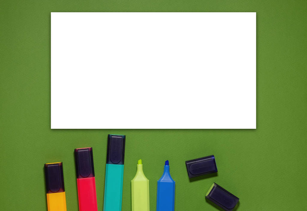 Multi-colored markers on a green background. Back to school conc - Photo, image