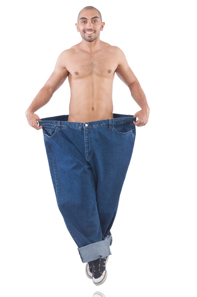 Homem em dieta conceito com jeans de grandes dimensões
 - Foto, Imagem