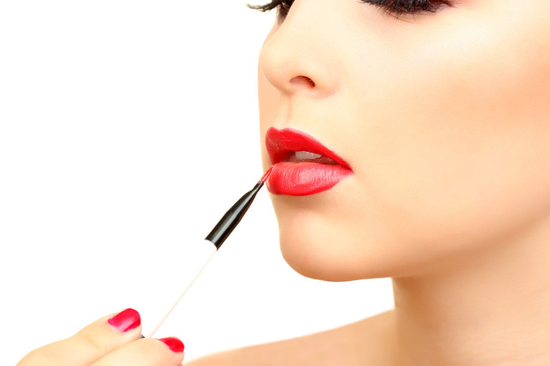 beautiful woman applying lip gloss - Фото, изображение