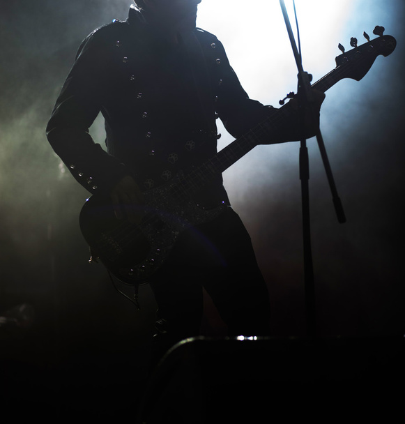gitarist silhouet in rook tijdens concert - Foto, afbeelding