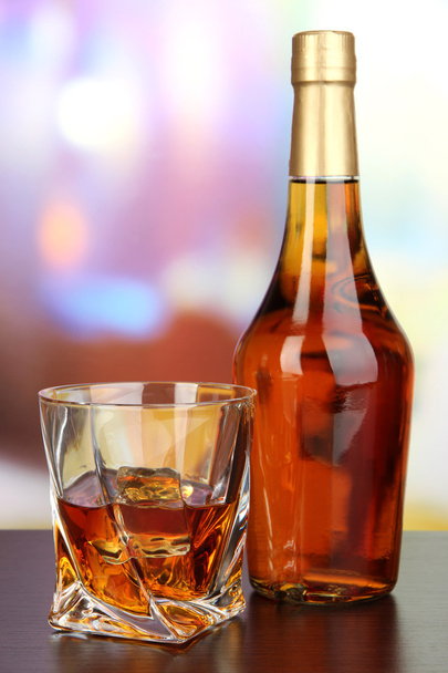 Glass of whiskey with bottle, on dark background - Fotografie, Obrázek