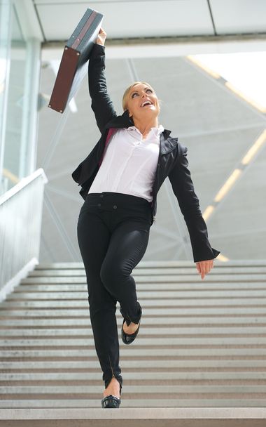 επιτυχημένη γυναίκα των επιχειρήσεων γιορτάζει με χέρια υψωμένα - Φωτογραφία, εικόνα