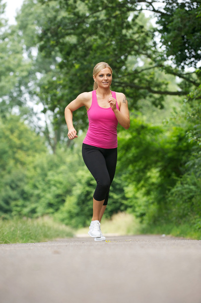 Fit young woman running in the park - Foto, Imagem